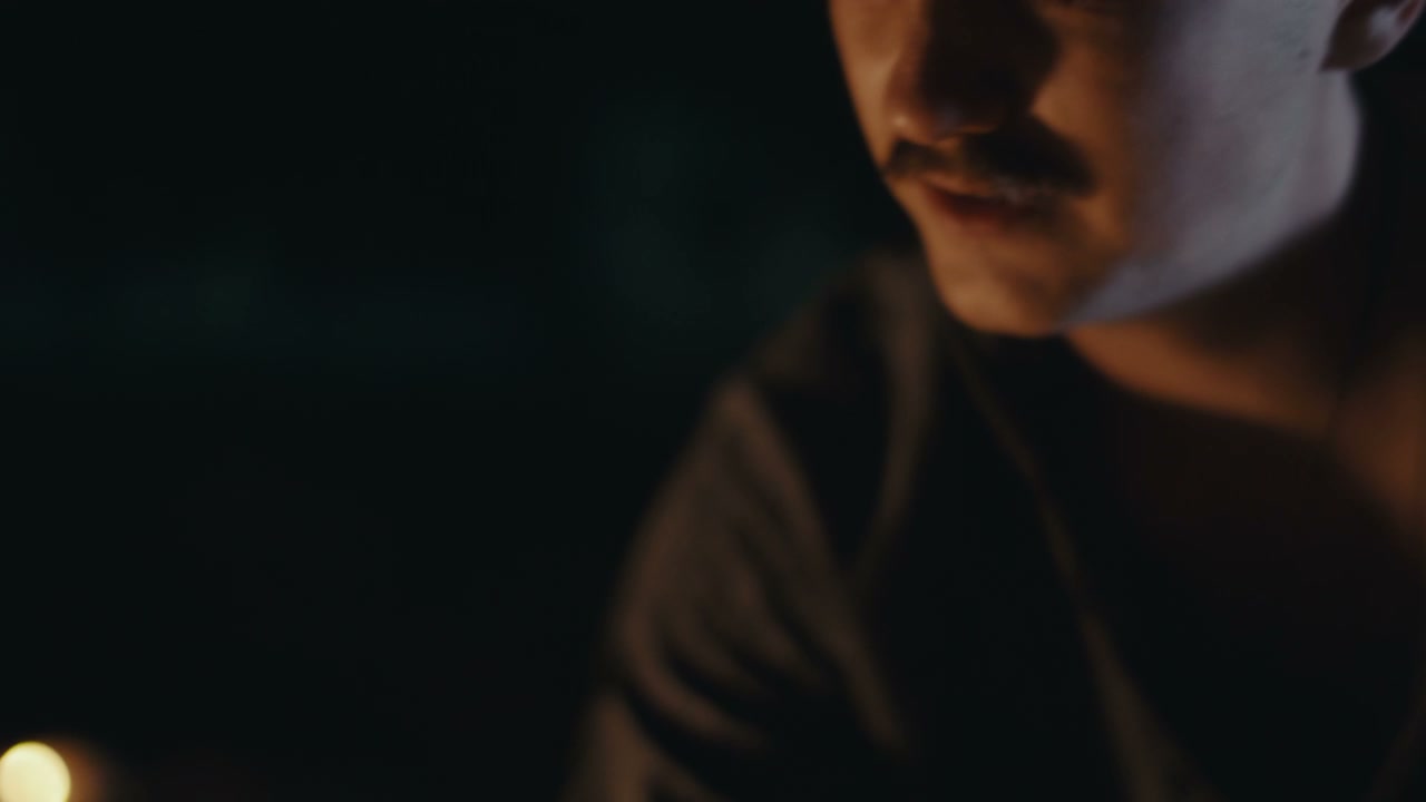 Man Performing Ritual by Firelight at Night