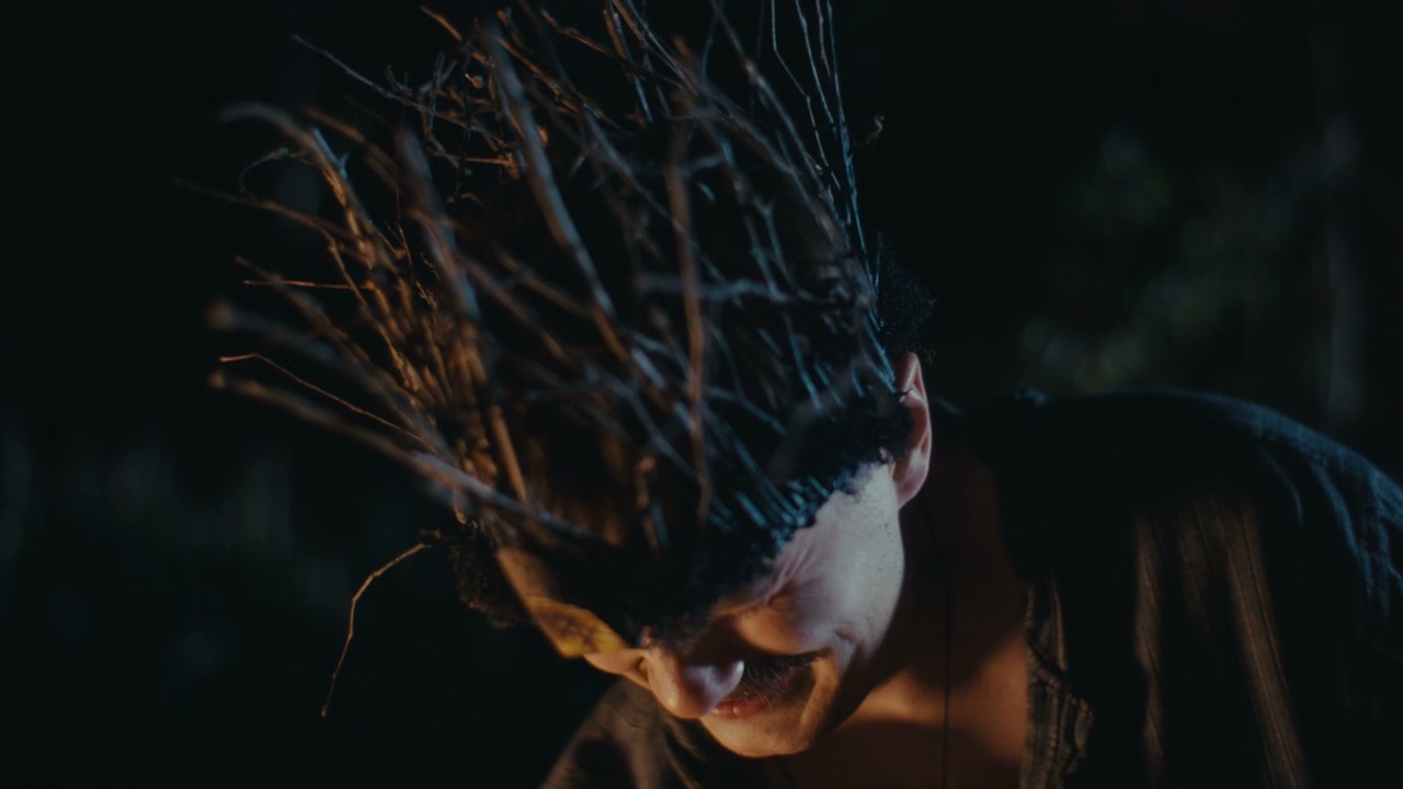 Man Performs Ancient Ritual with Stone at Night