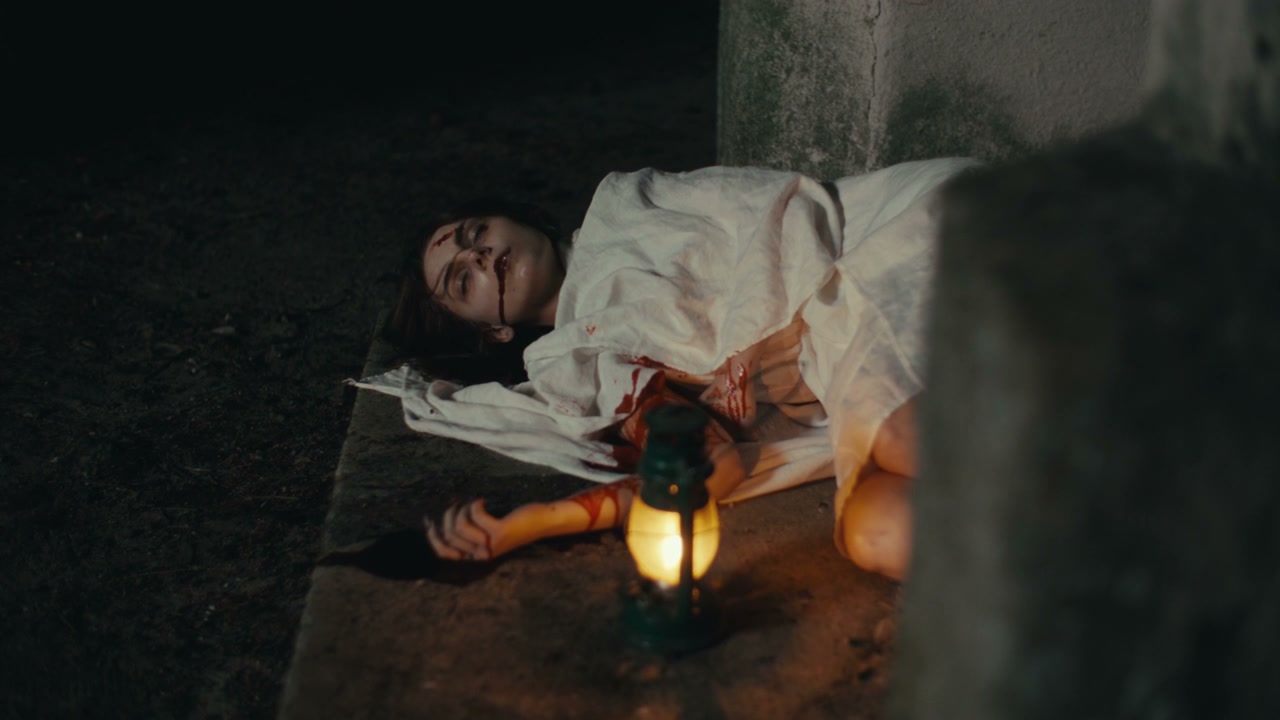 Bloody Person Lying Dead Next to Lantern