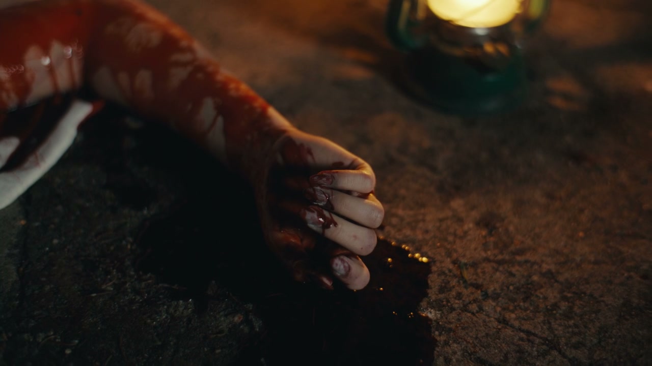 Bloody Hand on Ground at Night