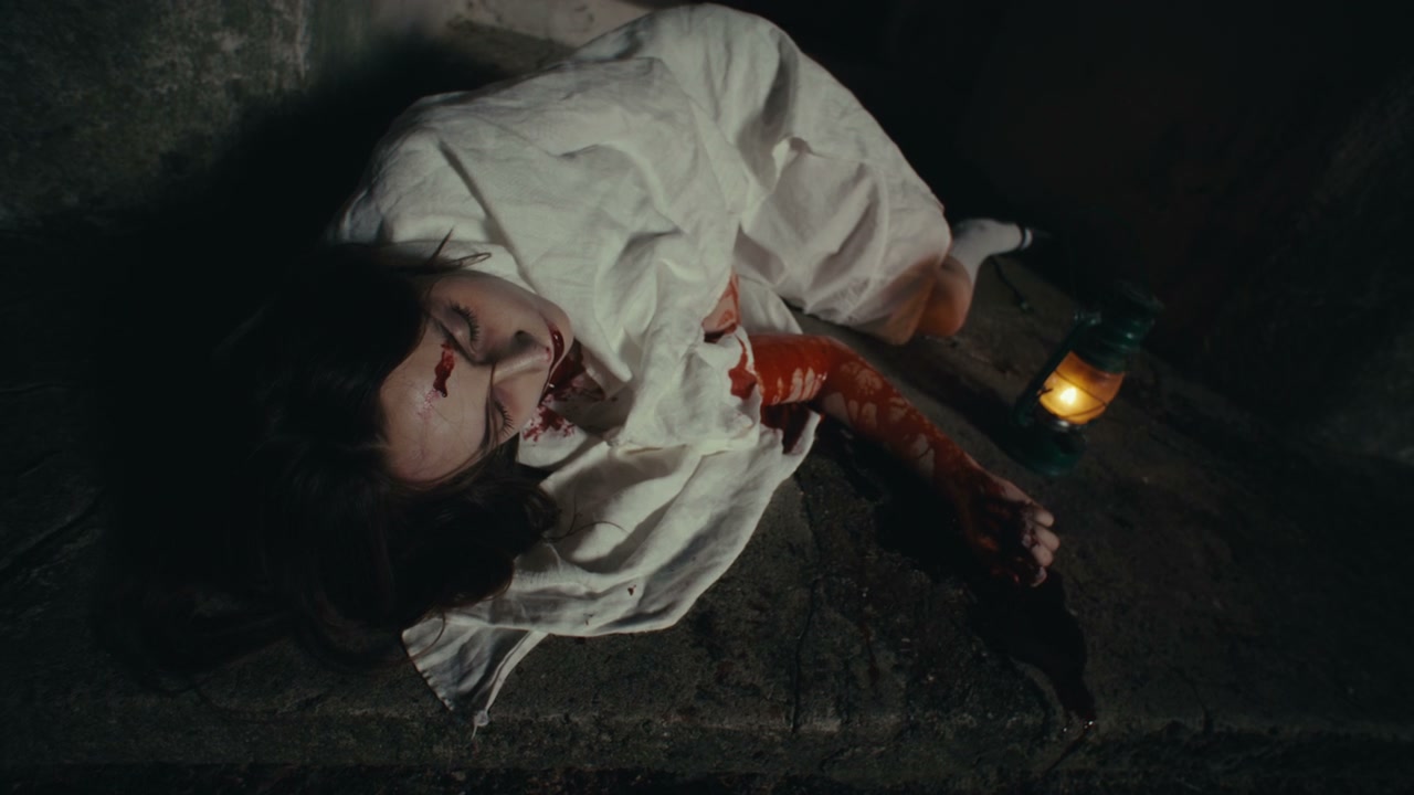 Bloodied Person Lying in Dark Ritual Scene