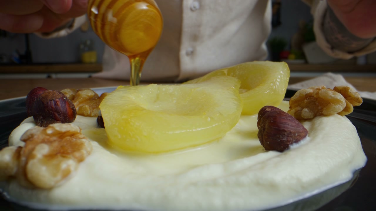 Pouring Honey on Poached Pears with Yogurt