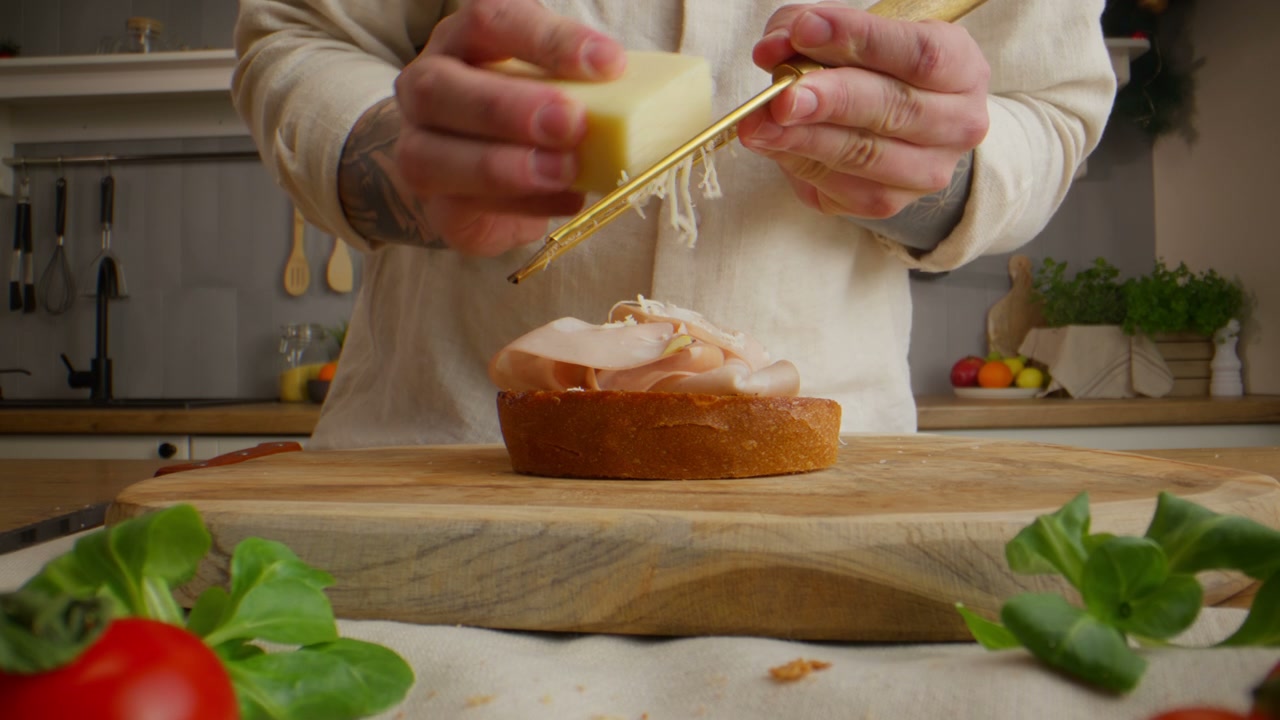 Person Grating Cheese for Open Sandwich