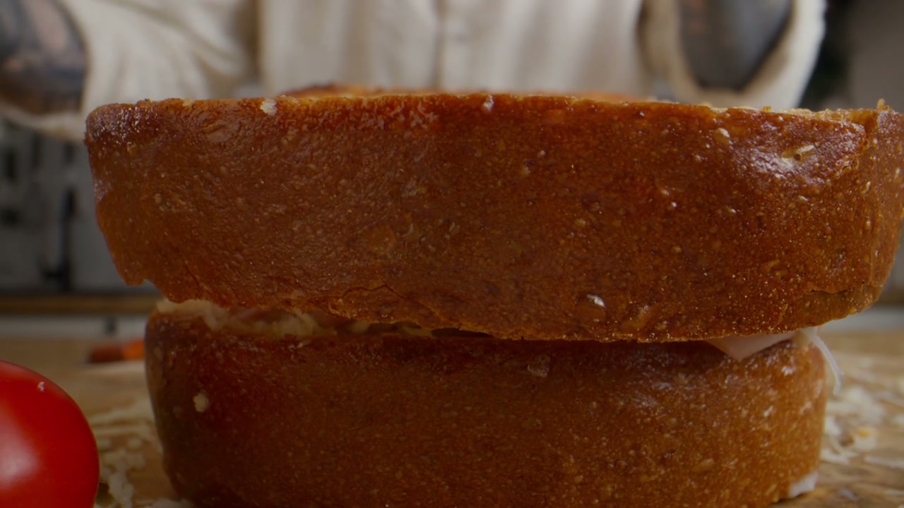 Assembling a Gourmet Ham and Cheese Sandwich