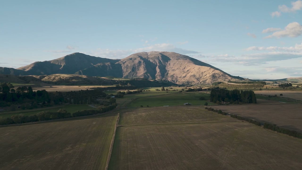 Aerial View of Vast Fields and Mountains