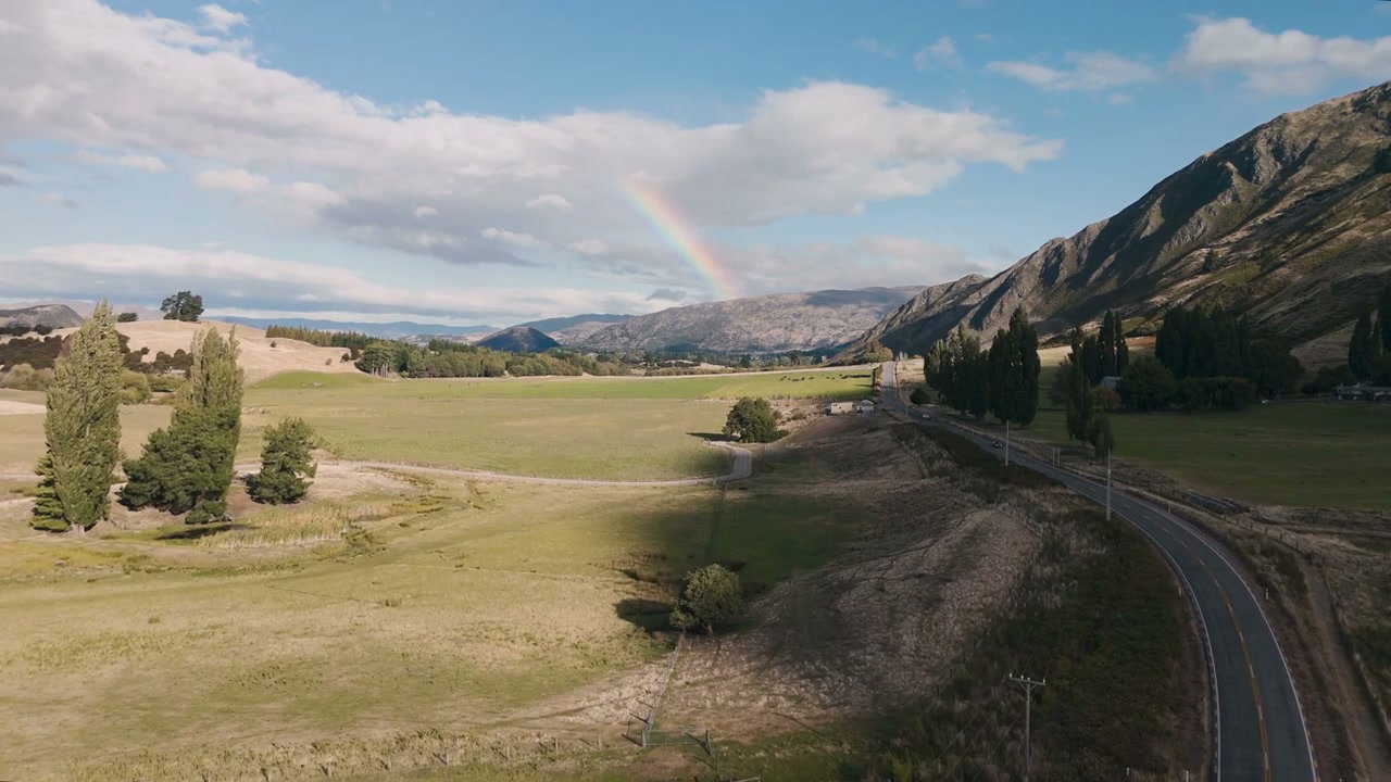 Rainbow Over Scenic Valley and Mountain Road