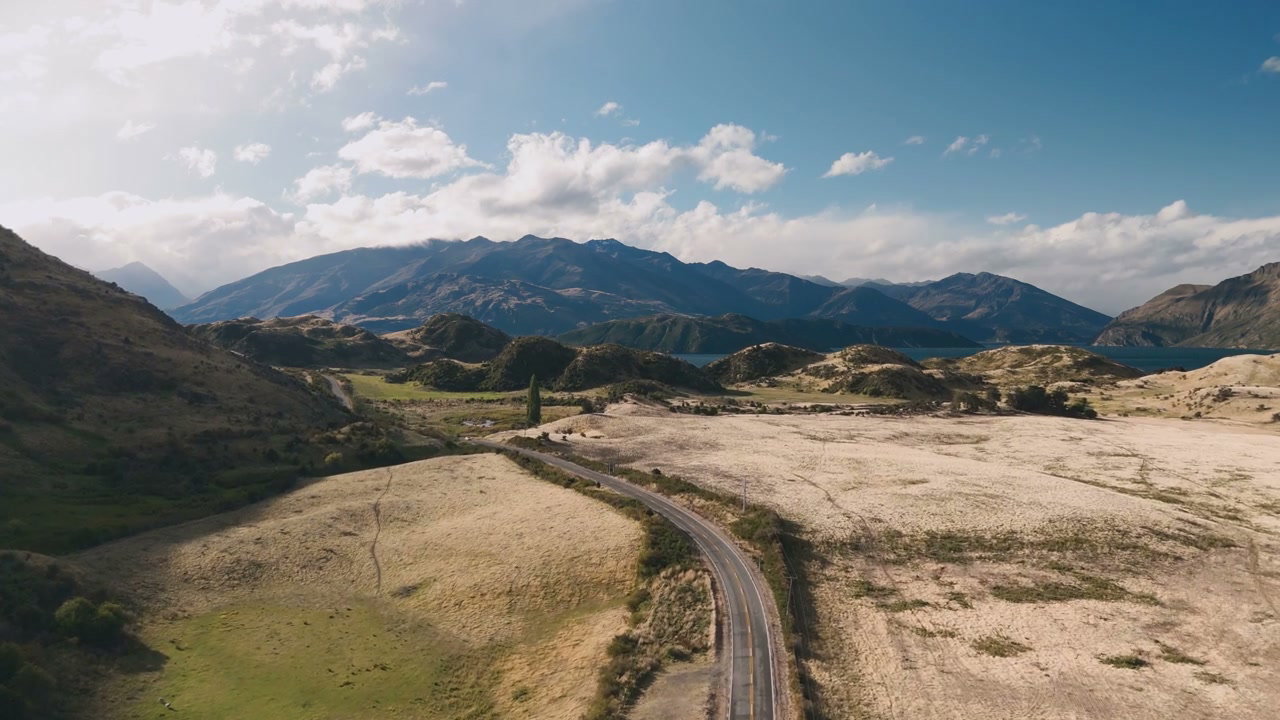 Road Winding Through Mountain Valley and Lake