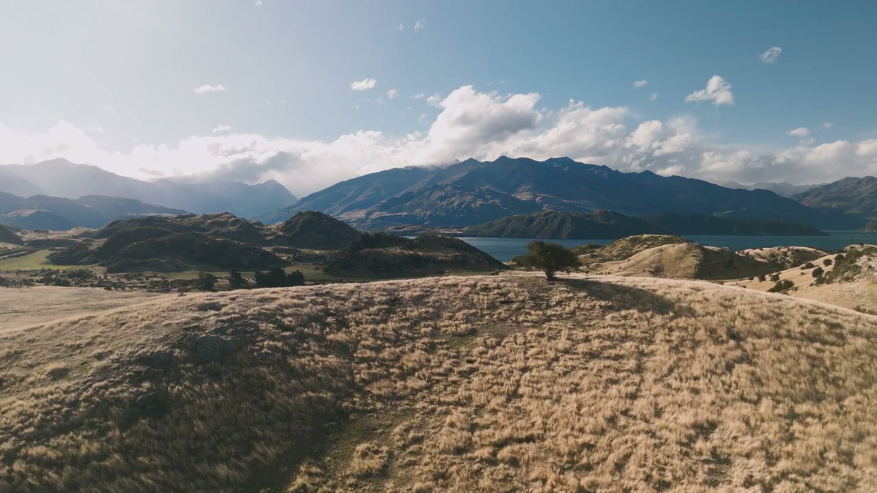 Golden Hills with Mountain Lake and Blue Sky