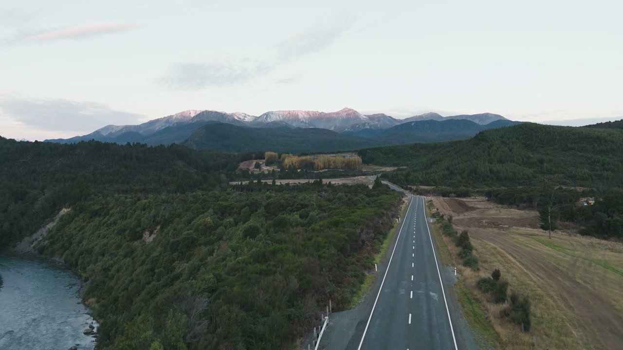 Scenic Road Winding Through Forest and Mountains