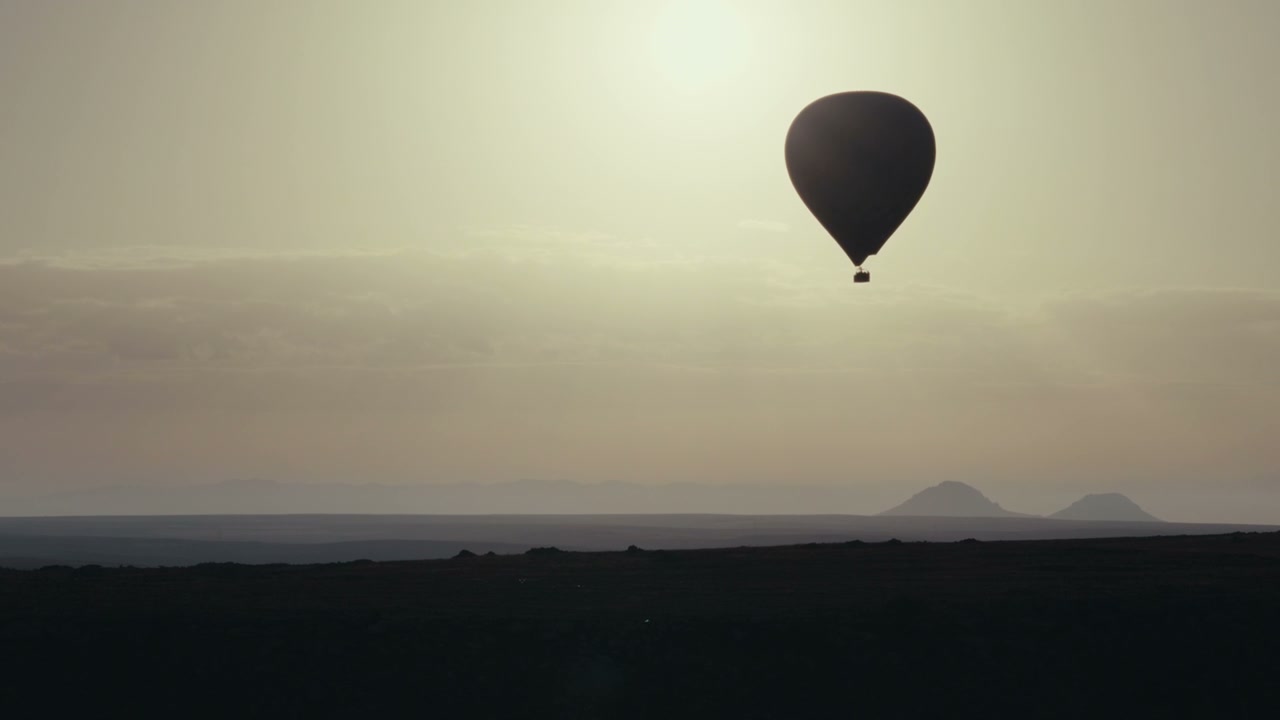 Hot Air Balloon Soaring Over Cappadocia Landscape