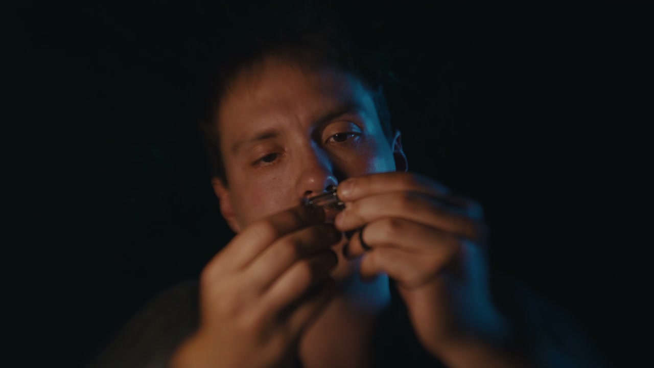 Man Attaching a Fake Mustache