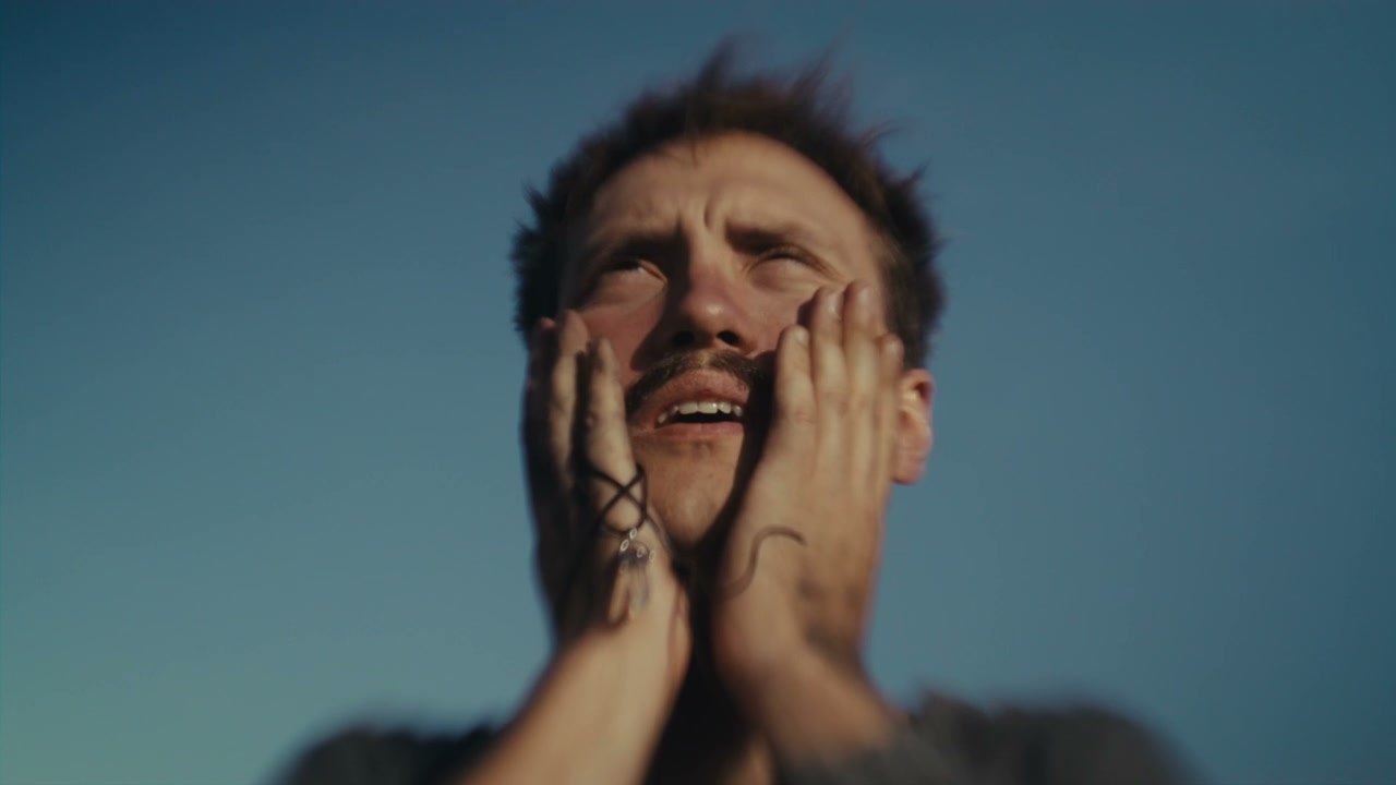 Distraught Man With Hands on Face Looking Up