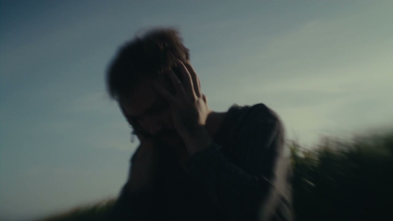 Distraught Person Covering Face in Field