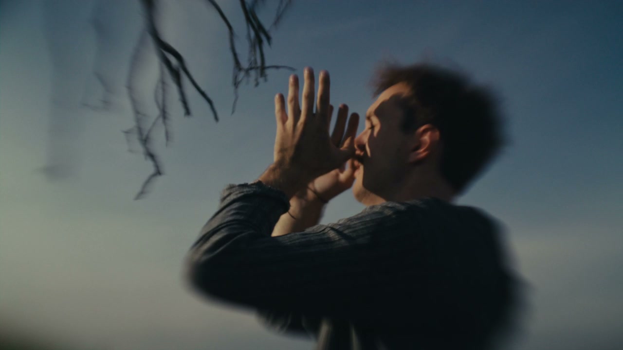 Distressed Man Crying Out Against Sky