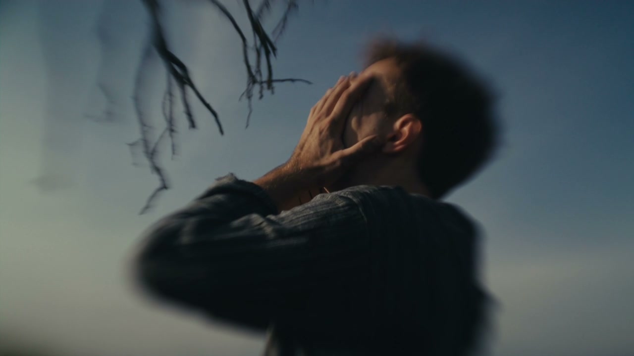 Man in Despair Covering Face Outdoors