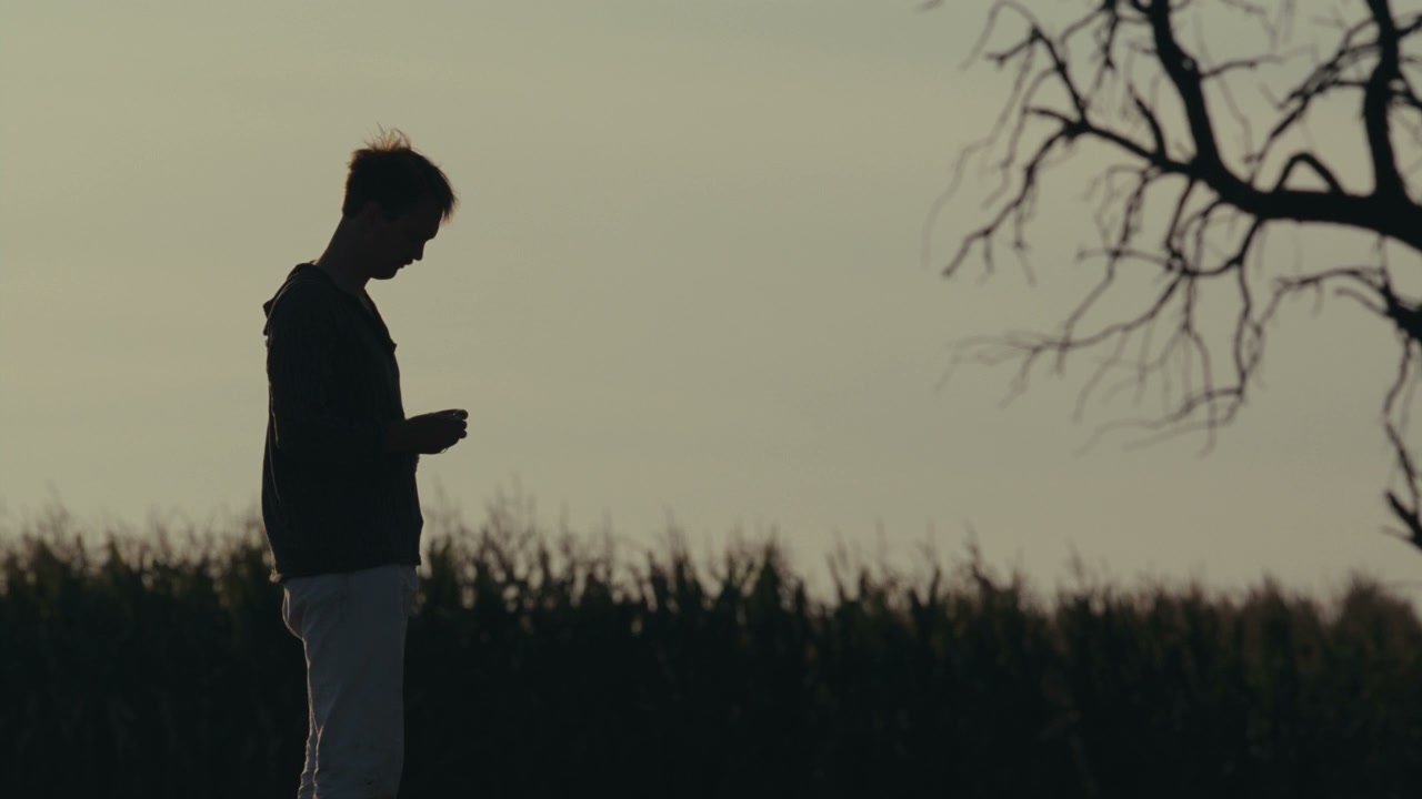 Lonely Young Person in Field at Sunset