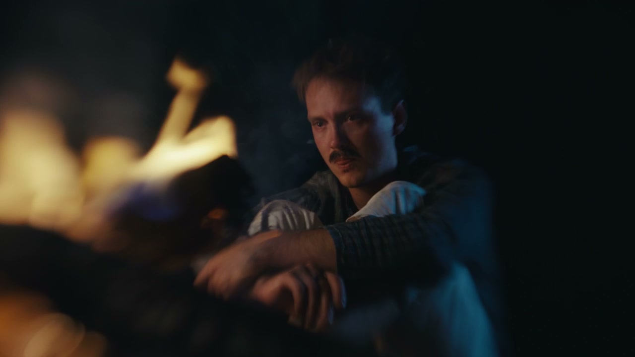 Heartbroken Man Sits by Campfire at Night
