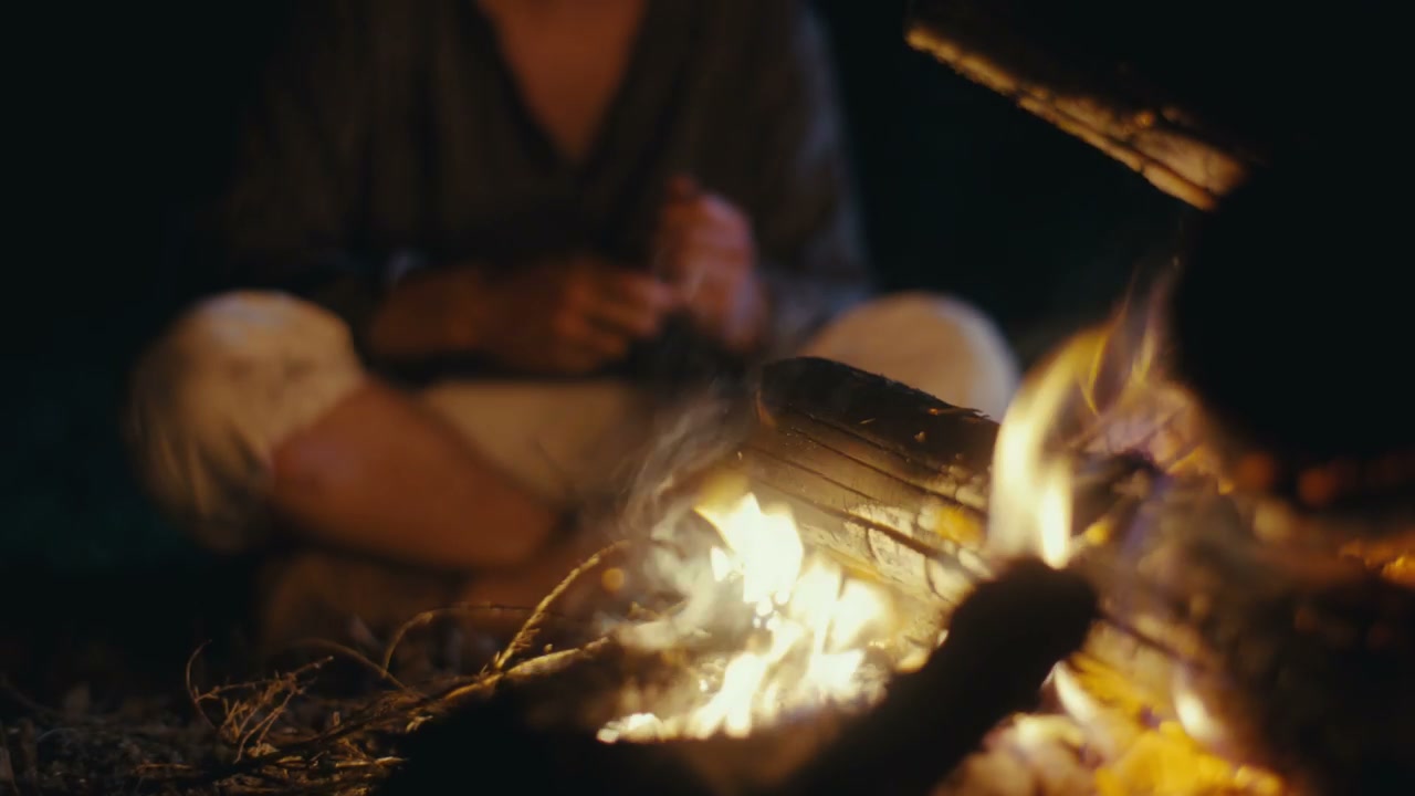 Man Contemplating by Night Campfire