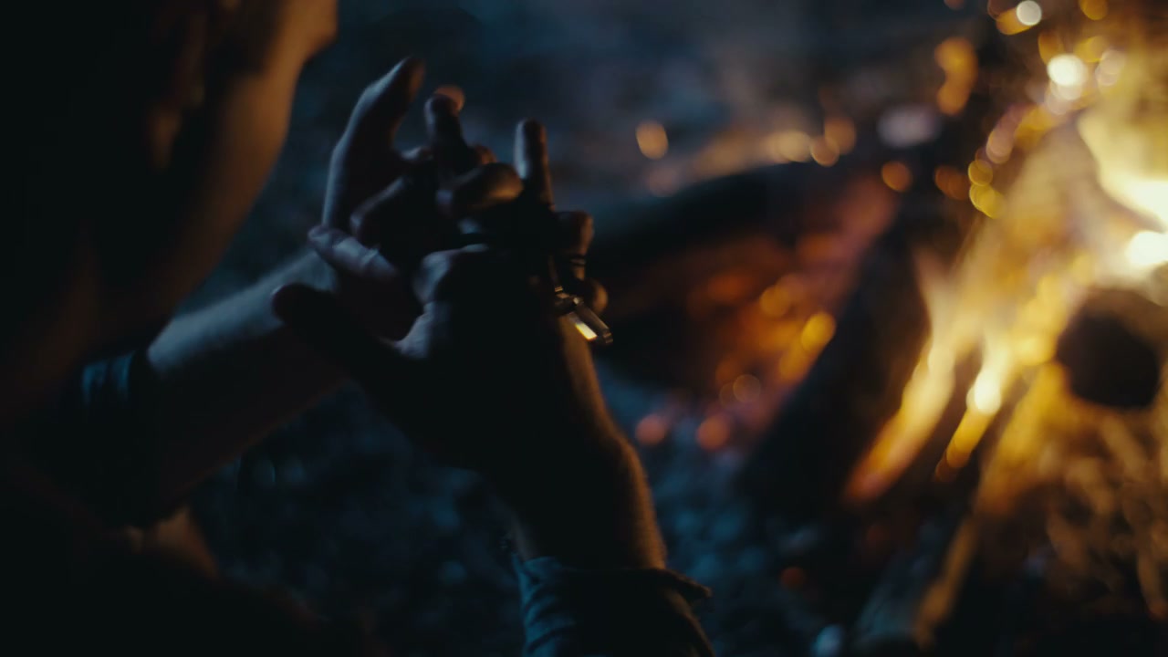 Hands Warming by Campfire at Night