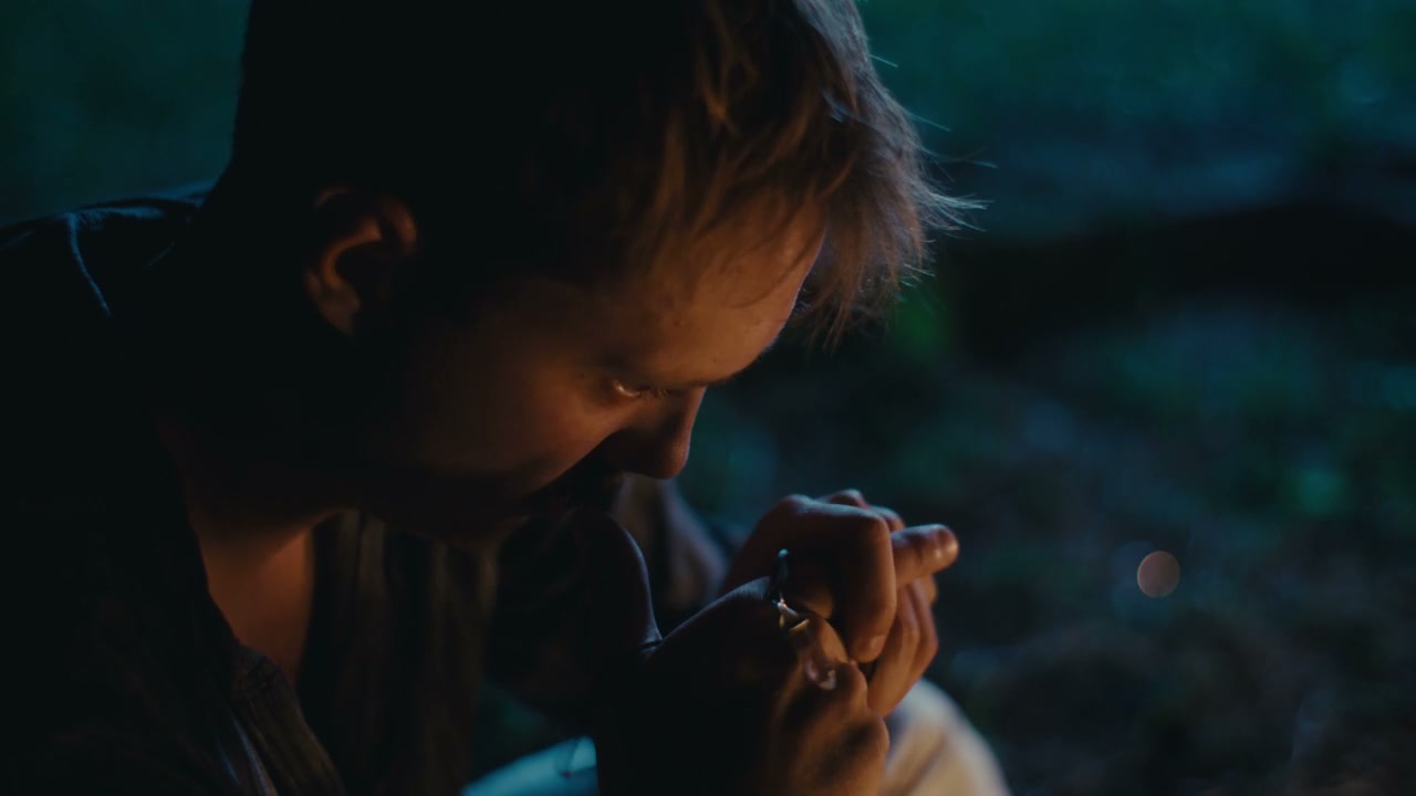 Sad Man Holding Ring by Firelight at Night