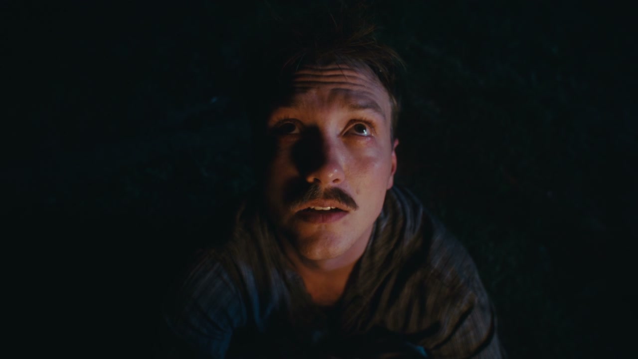 Pensive Man Looking Up in Dark