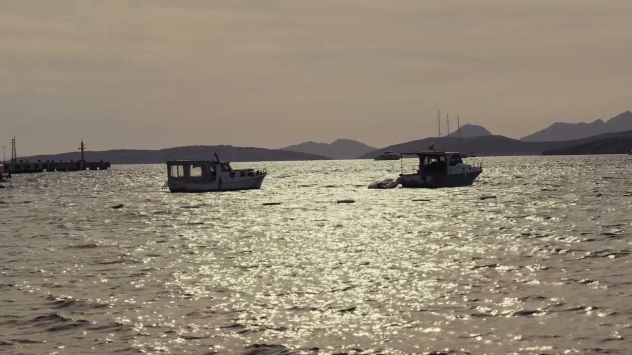Fishing Boats on Shimmering Sea at Golden Hour