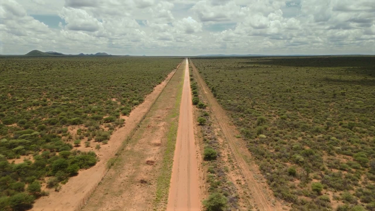 Straight Dirt Road in African Landscape