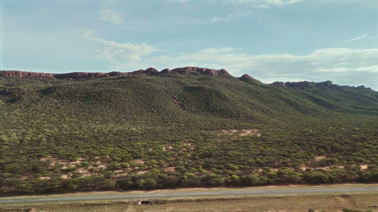 African Savanna Landscape with Mountains and Road