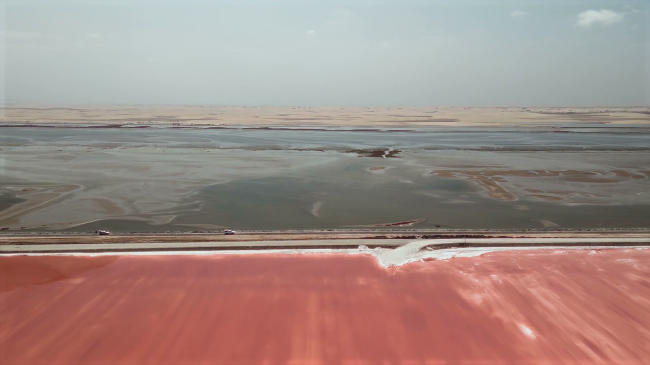 Pink and Grey Salt Lakes Divided by Road