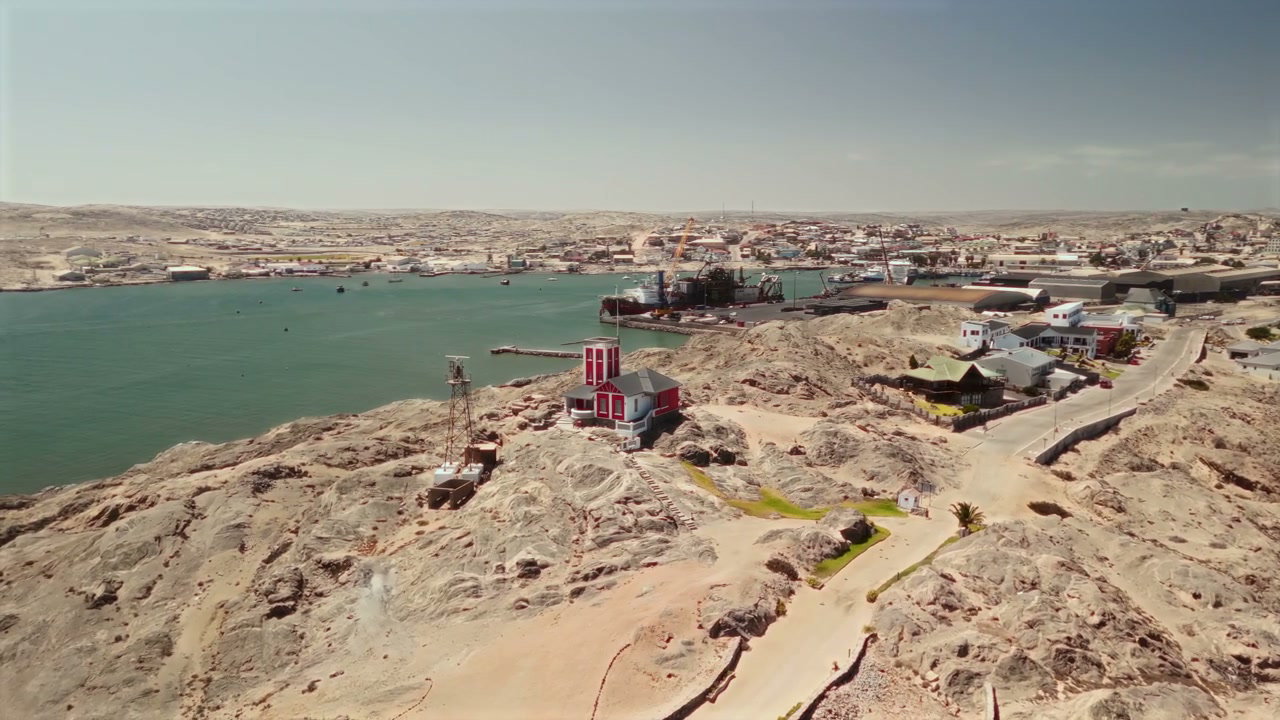 Coastal Town with Harbor and Arid Landscape