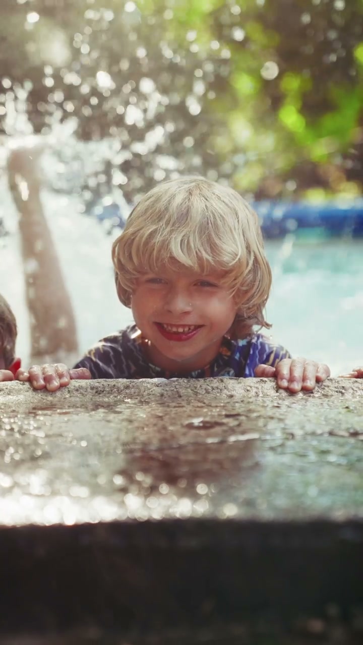 Boy Jumps and Makes Big Splash in Pool • Stock Video on Uppbeat
