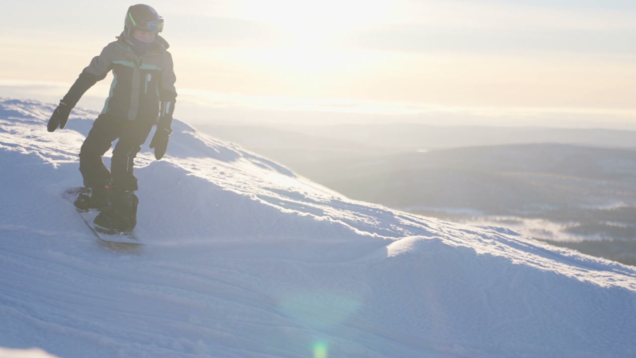 Snowboarder Descending Sunny Winter Slope