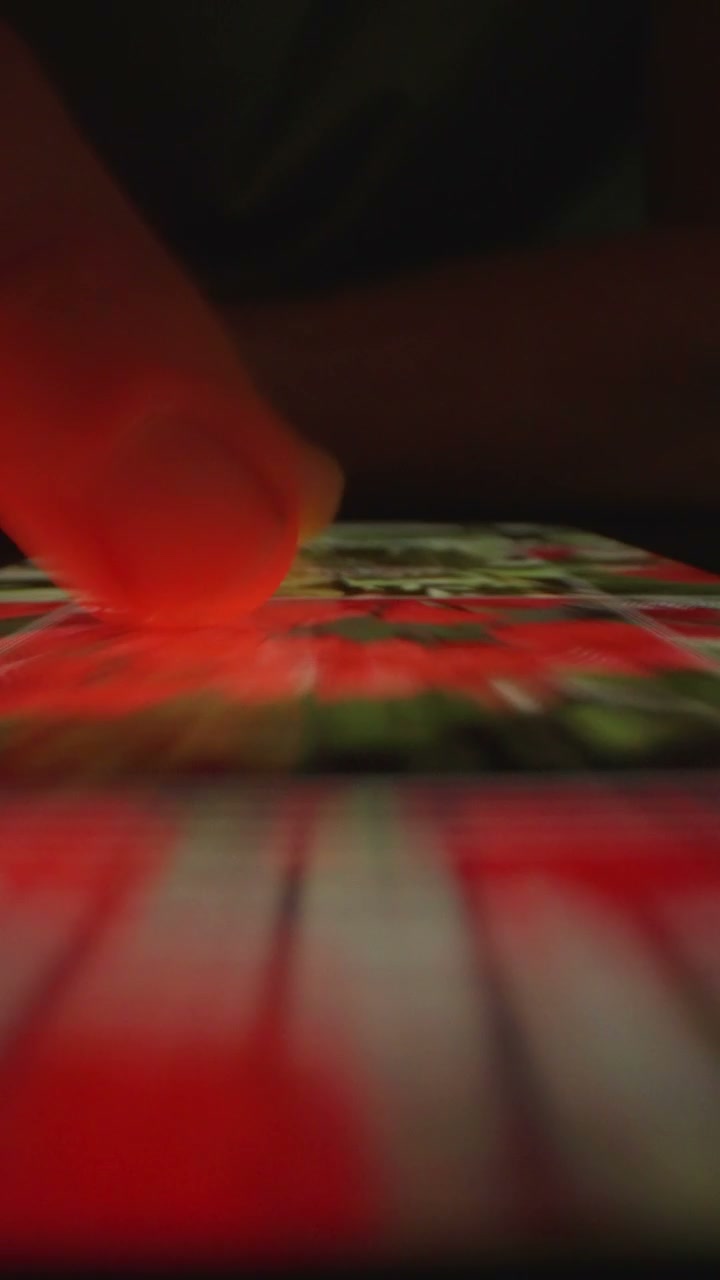 Finger Swiping Through Photo Gallery on Smartphone