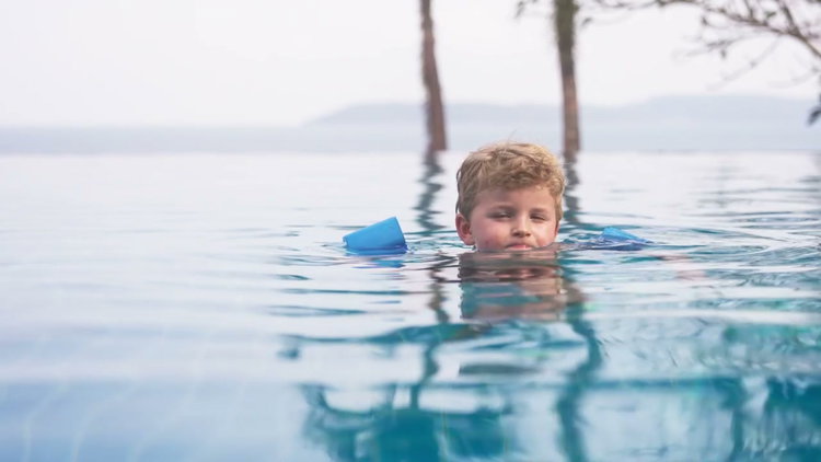 Boy Floating in Inflatable Ring in Swimming Pool • Stock Video on Uppbeat