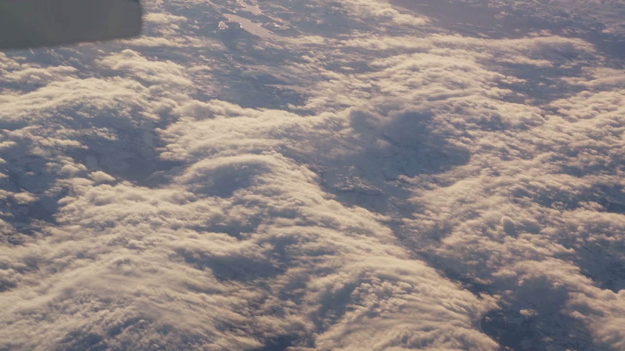 Golden Clouds Above Snow-Capped Mountains
