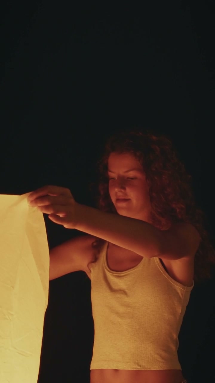 Person Holding Glowing Lantern
