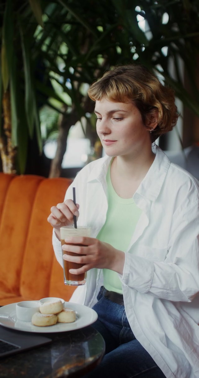 Woman Working and Sipping Drink in Cafe • Stock Video on Uppbeat