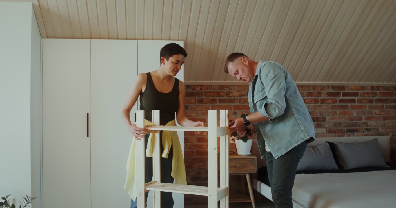 Couple Assembling Wooden Shelf in Bedroom