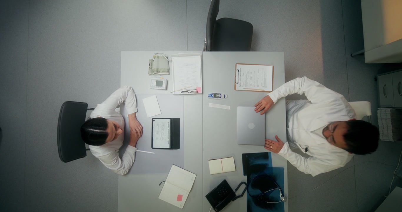 Top-Down Doctors Working at Clinic Desk