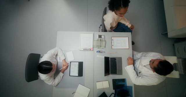 Top-Down Doctors Working at Clinic Desk • Stock Video on Uppbeat