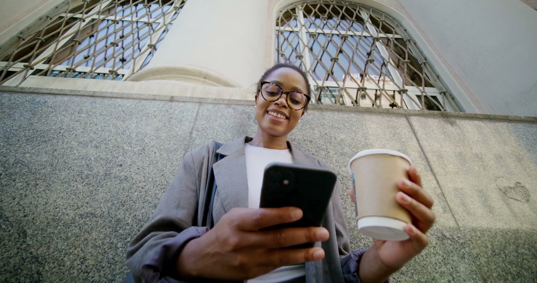 Woman at Cafe Drinking Coffee and Using Phone • Stock Video on Uppbeat