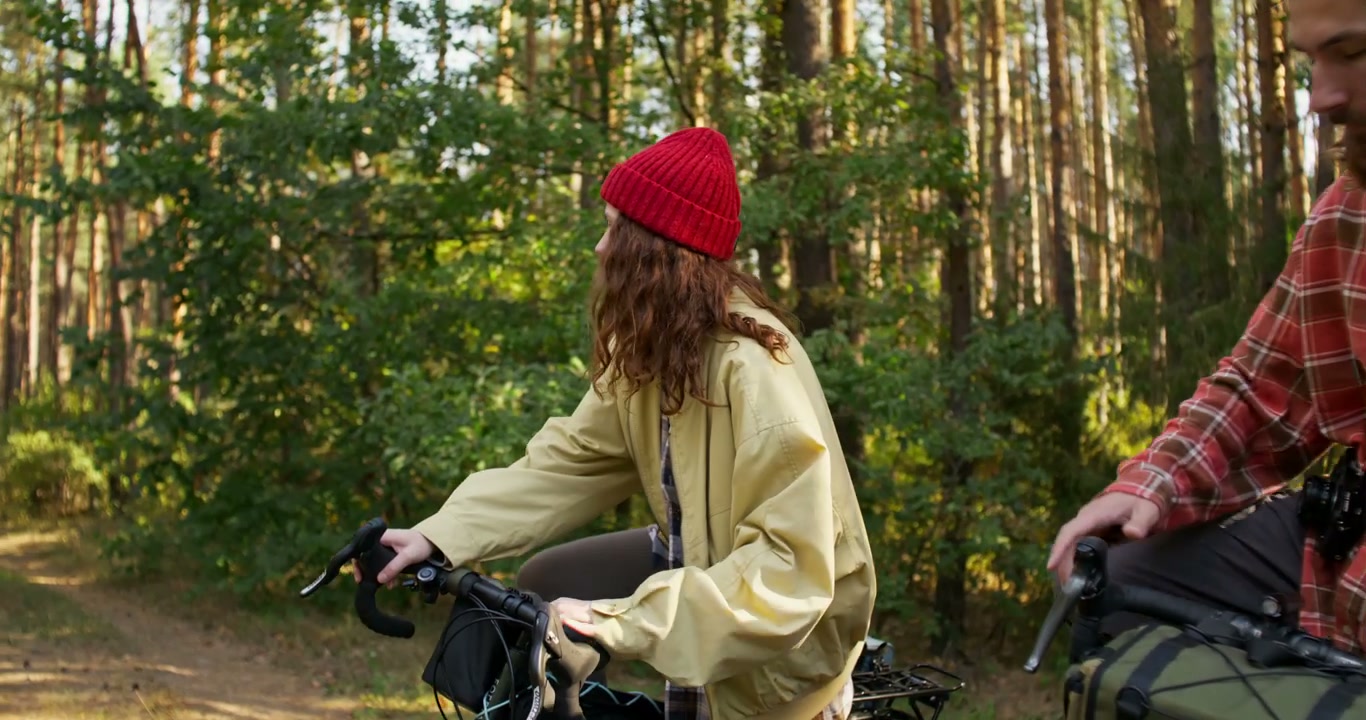 Couple Cycling Through Sunny Forest