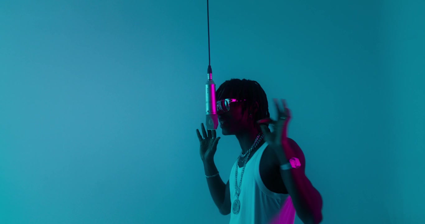 Young Rapper Performing in Neon Lit Studio