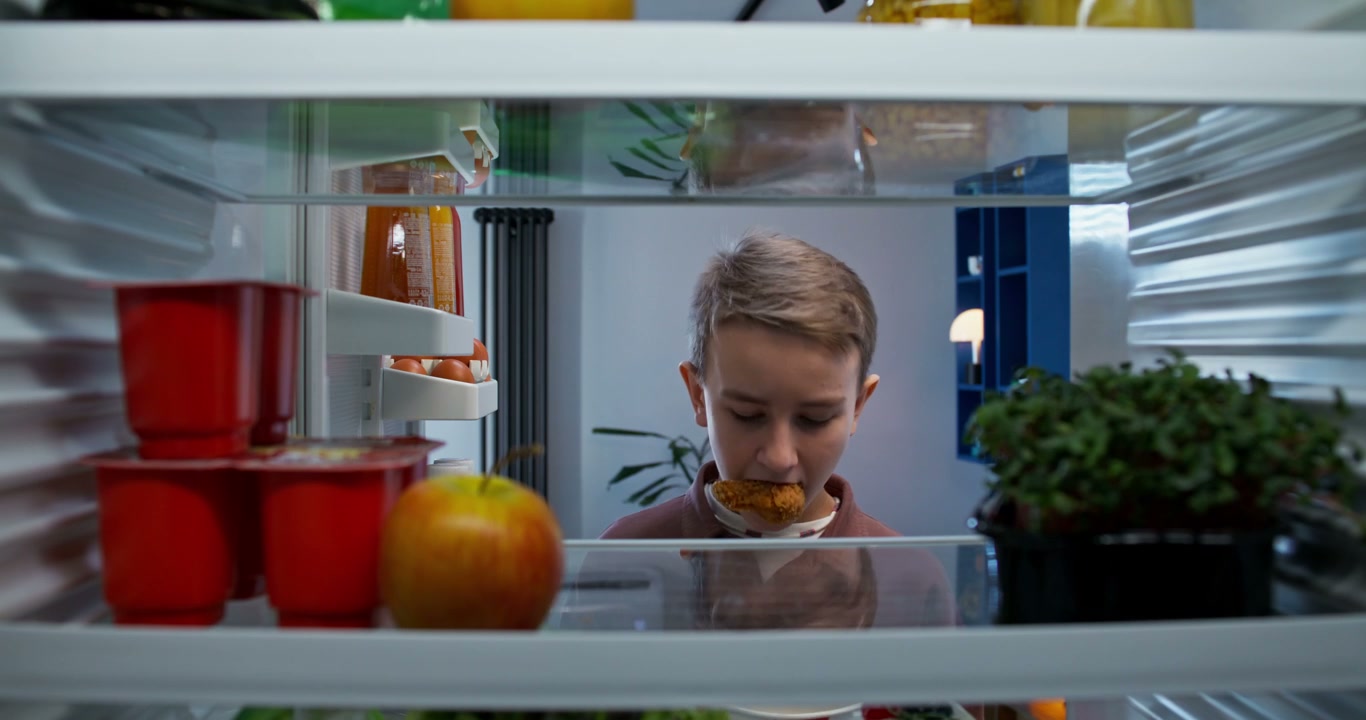 Child Eating and Storing Fast Food in Fridge