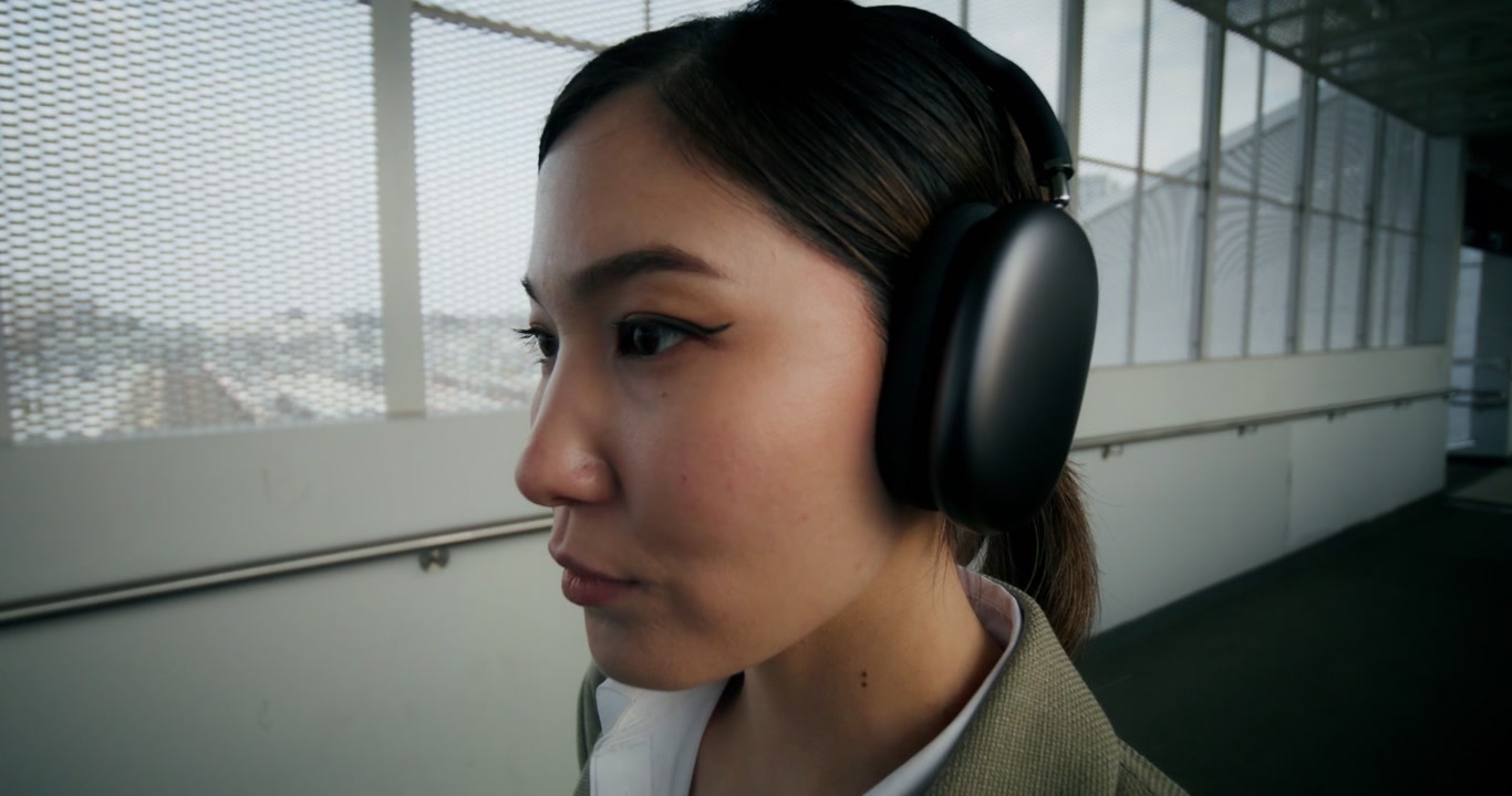Focused Woman Wearing Headphones at Station