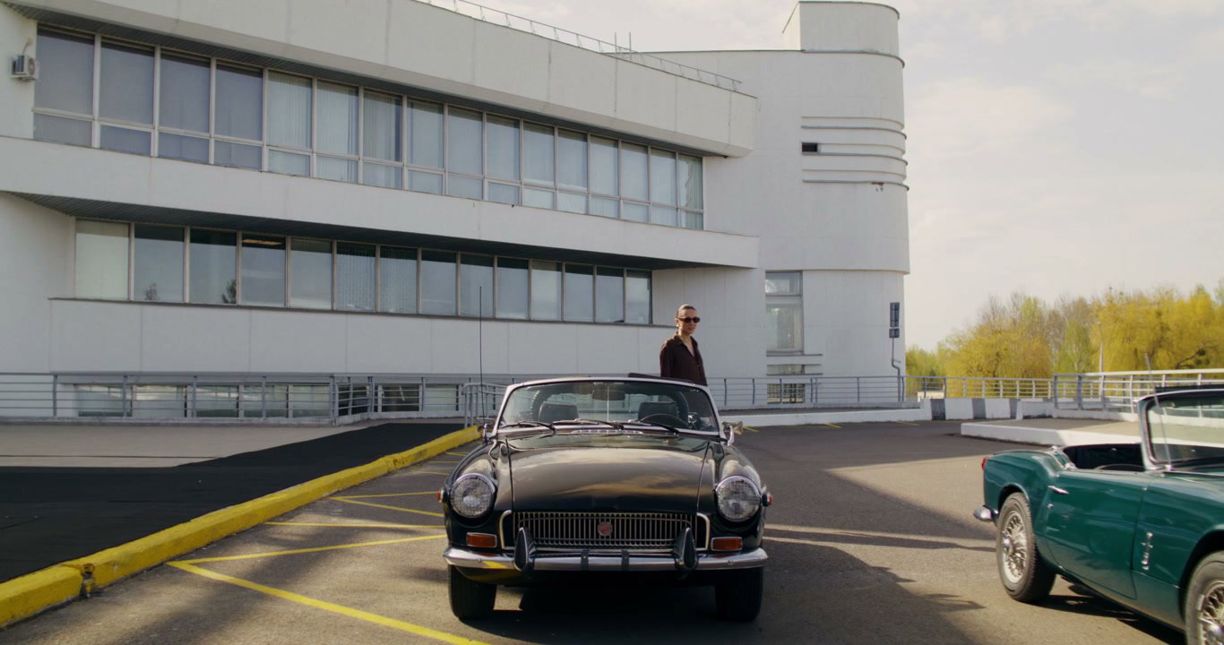 Elegant Woman Gets Into Retro Convertible