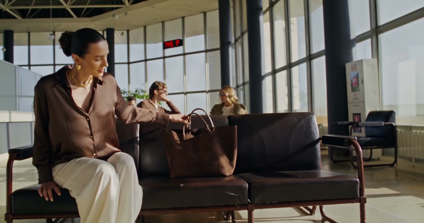 Elegant Woman Rests in Airport Lounge