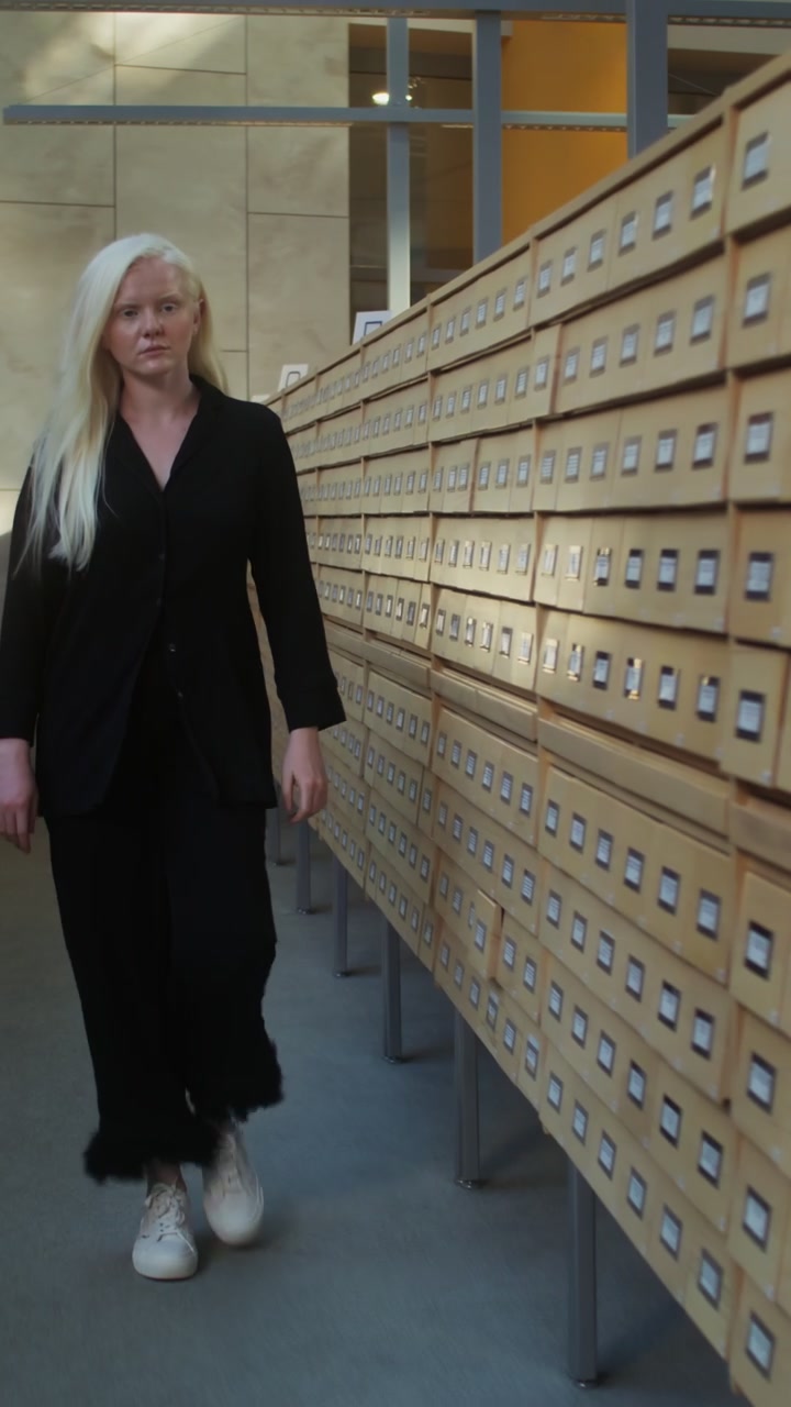 Person Walking Past Archive Cabinets