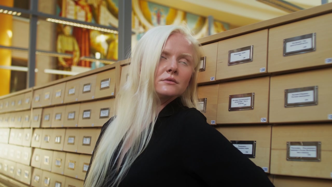 Albino Woman by Library Card Catalog
