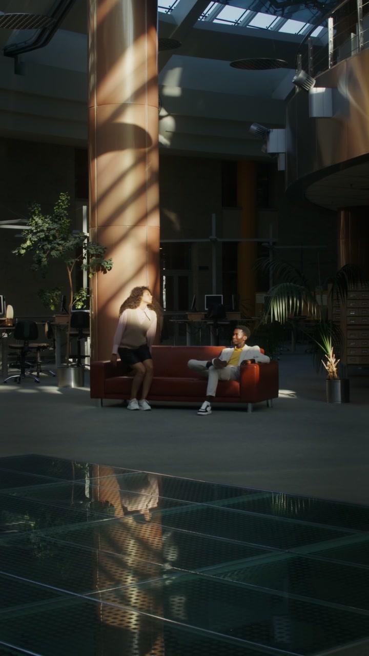Woman Rests on Sofa in Office Sunlight